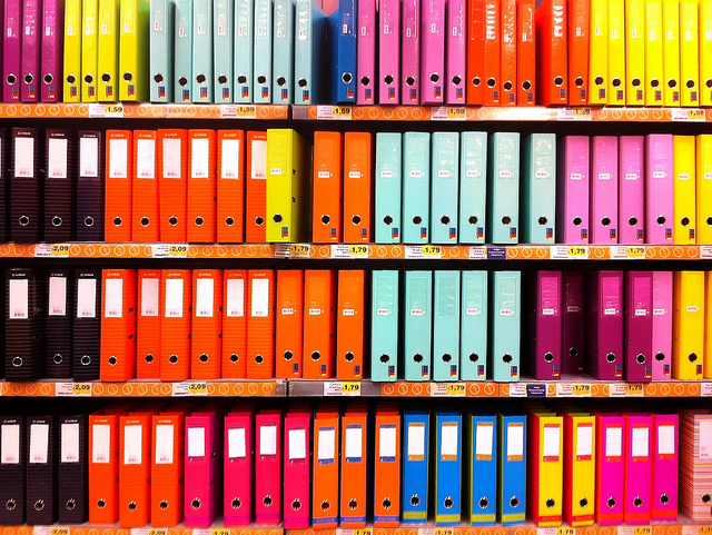 Photo of shelves full of brightly colored binders