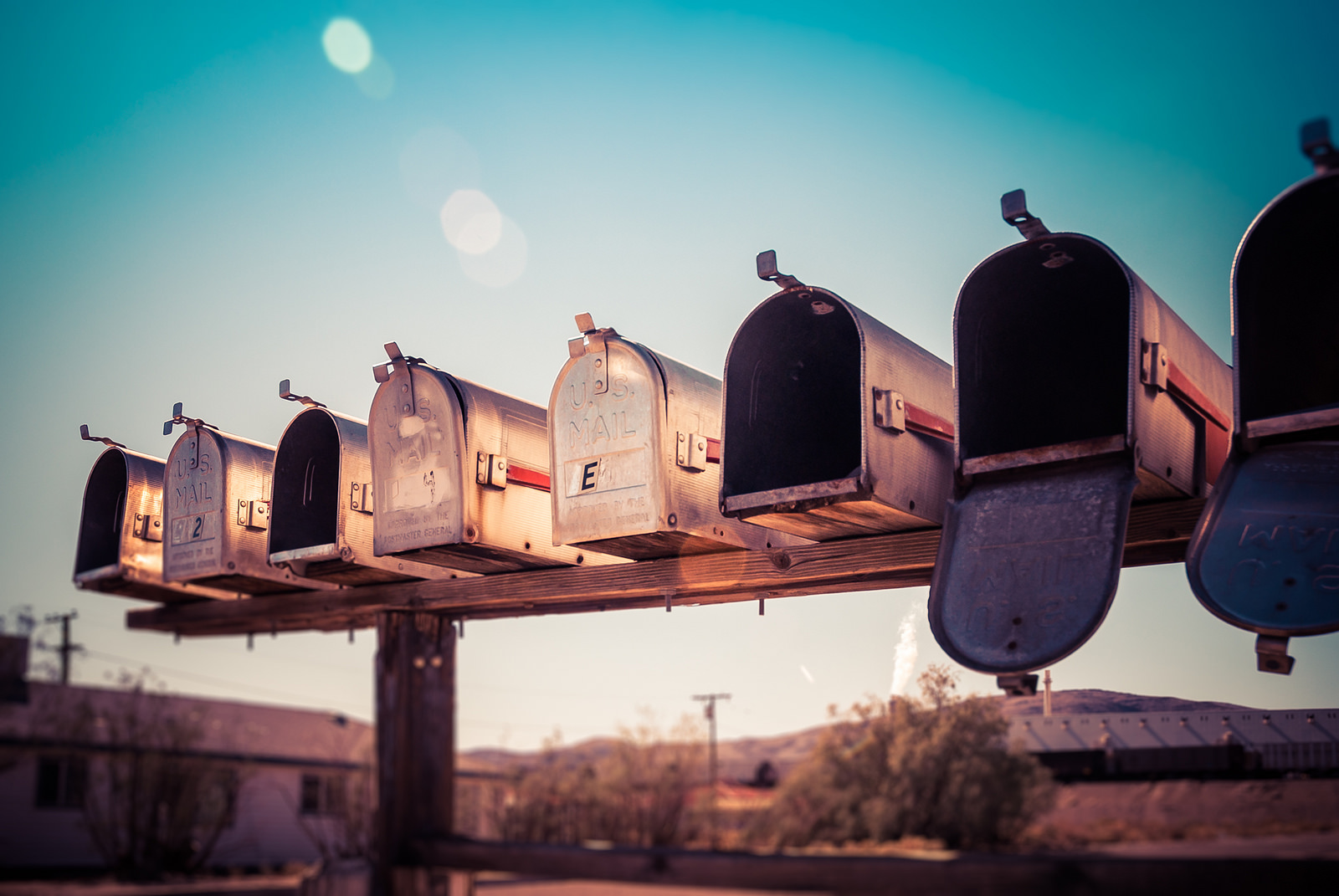 Photo of a row of mailboxes, mostly empty