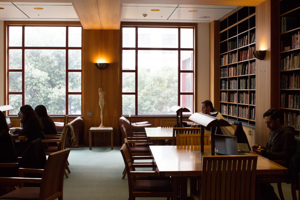 picture of people at study tables inside the UCSF library
