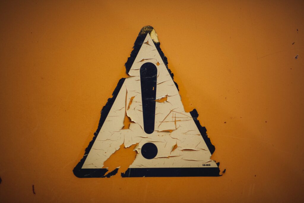 Chipping decal of a black exclamation mark on a white triangle, on a yellow background