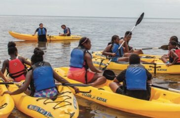Summer camp participants on a guided kayaking tour off the coast of Crandon Park