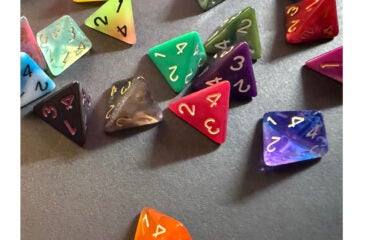 Cover of Analog Game Studies Volume 13, Number 1, March 2026, featuring a photo of 4-sided dice in a variety of colors by Edmond Y. Chang.